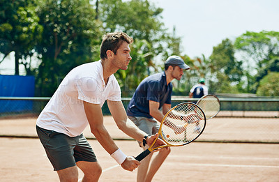 Buy stock photo Shot of two tennis players on the
same team waiting for the ball

