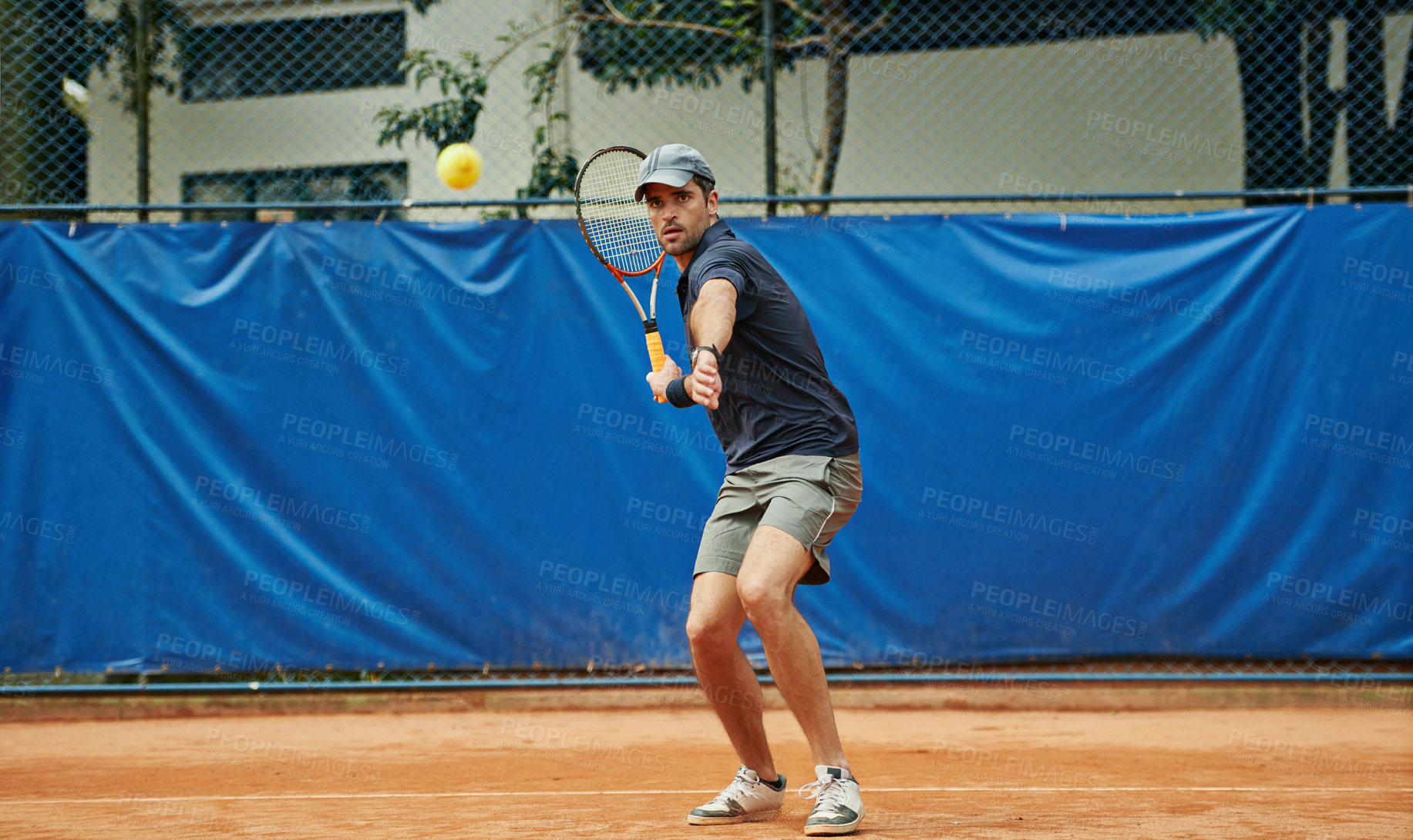 Buy stock photo Man, tennis ball and game in outdoor court, sports and play for competition or practice. Male person, athlete and ready for training or exercise, workout and match for action and challenge fitness