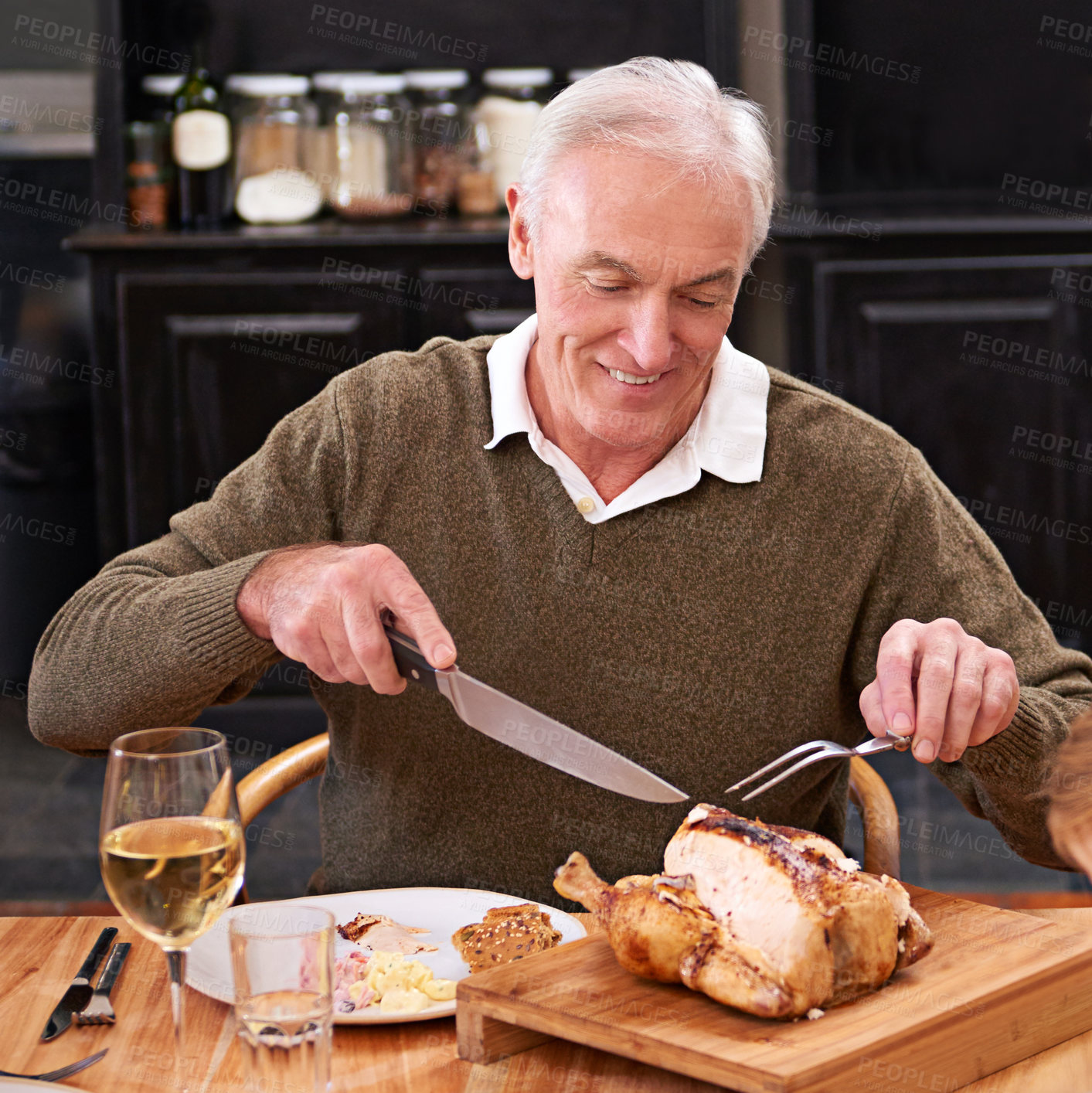 Buy stock photo Old man, home and roast chicken with knife, dinner and eating with healthy meal, delicious and tasty. Pensioner, apartment and senior person with wine, food and meat with alcohol, cutting and hunger