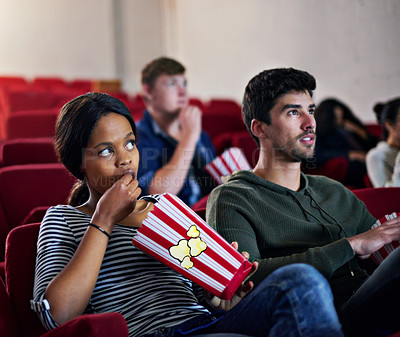Buy stock photo Thriller, movie and couple in cinema on date with popcorn to relax and watch in theatre with suspense. Film, experience and people in audience enjoy horror, drama performance or eating snack food