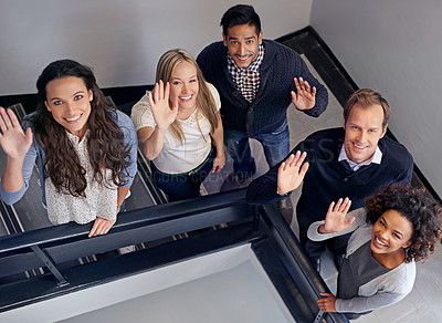 Buy stock photo Business colleagues standing on the stairs waving