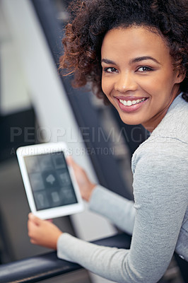 Buy stock photo Portrait of an attractive young woman holding a digital tablet 