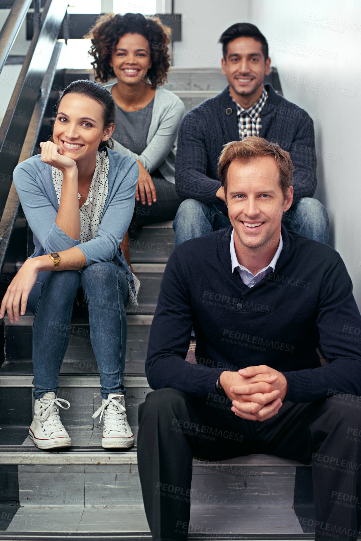Buy stock photo Portrait of a group of office coworkers sitting in a stairwell