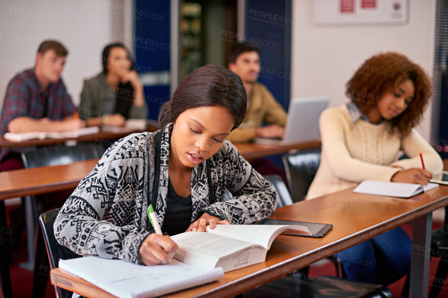 Buy stock photo Shot of students working diligently in class