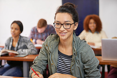 Buy stock photo Portrait shot of a happy female student sitting at her desk