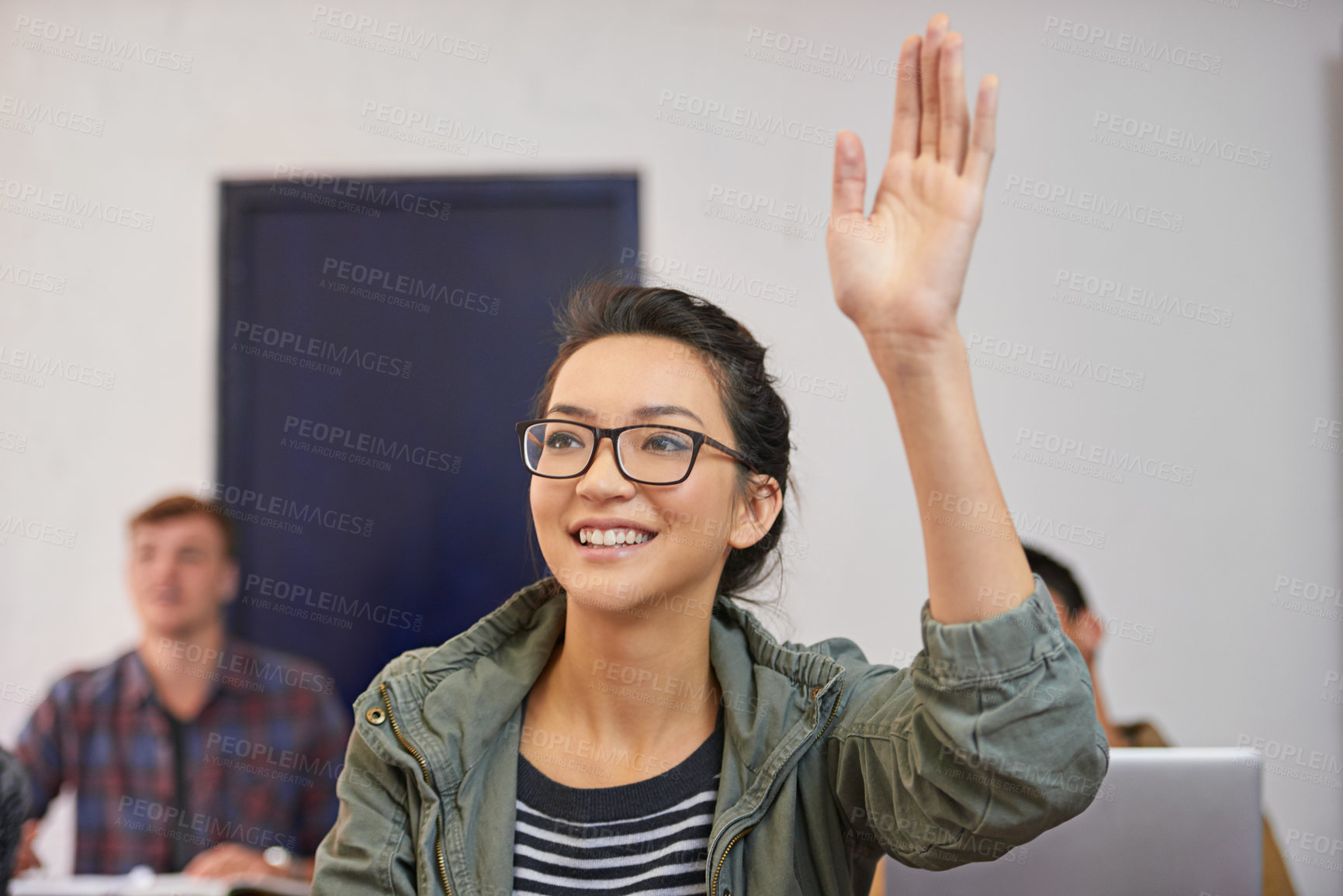 Buy stock photo Shot of a young woman raising her hand to ask a question in class