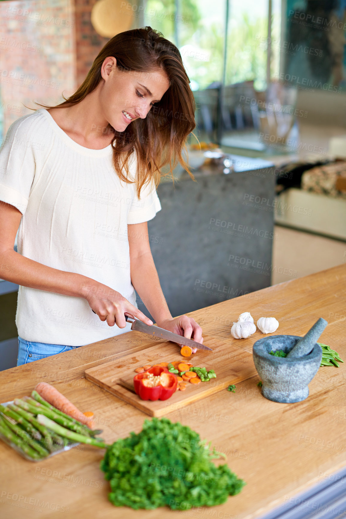 Buy stock photo Cooking, home and happy woman with food, meal prep and cutting fresh vegetables for gut health. Diet, digestion and female person in kitchen with ingredients, nutrition and wellness in apartment.