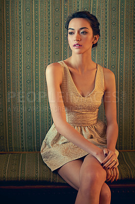 Buy stock photo Shot of a beautiful young woman wearing an elegant gold dress indoors