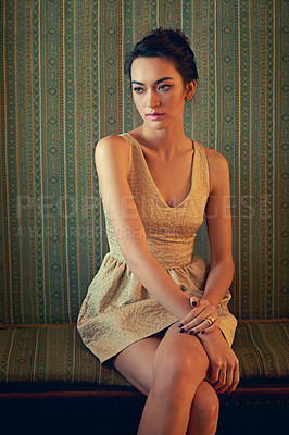 Buy stock photo Shot of a beautiful young woman wearing an elegant gold dress indoors