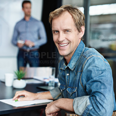 Buy stock photo Portrait of an office worker with his colleagues sitting in the background