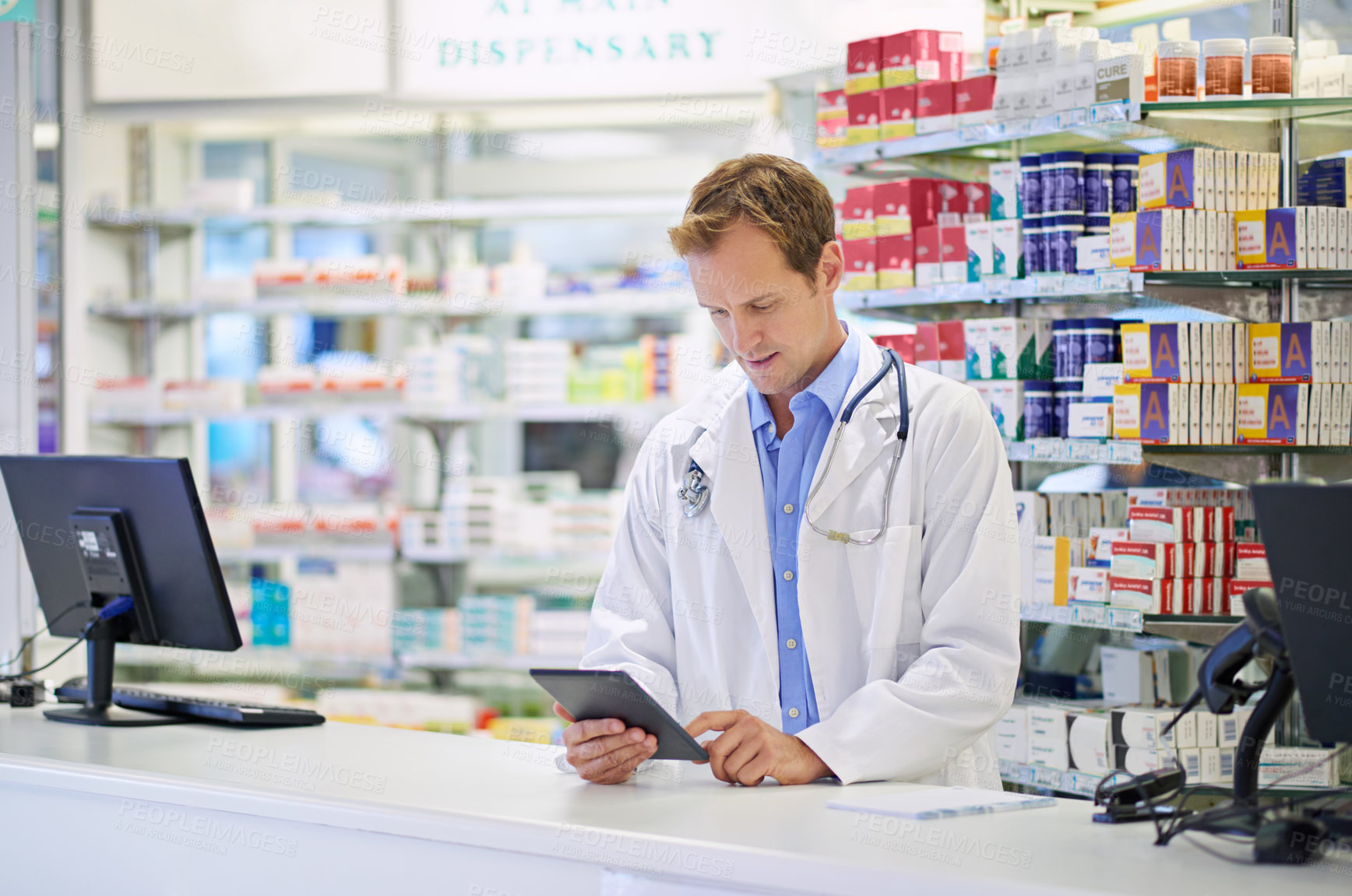 Buy stock photo A pharmacist working on a digital tablet