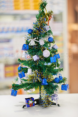 Buy stock photo A tiny christmas tree on a counter