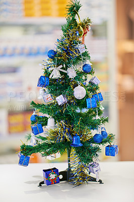 Buy stock photo Christmas tree, gifts and decoration at pharmacy, counter and medicine in drugstore, chemist or services. Holiday, festive season and pharmaceuticals for prescription, pills for celebration in shop