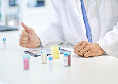 Buy stock photo A pharmacist working on a digital tablet