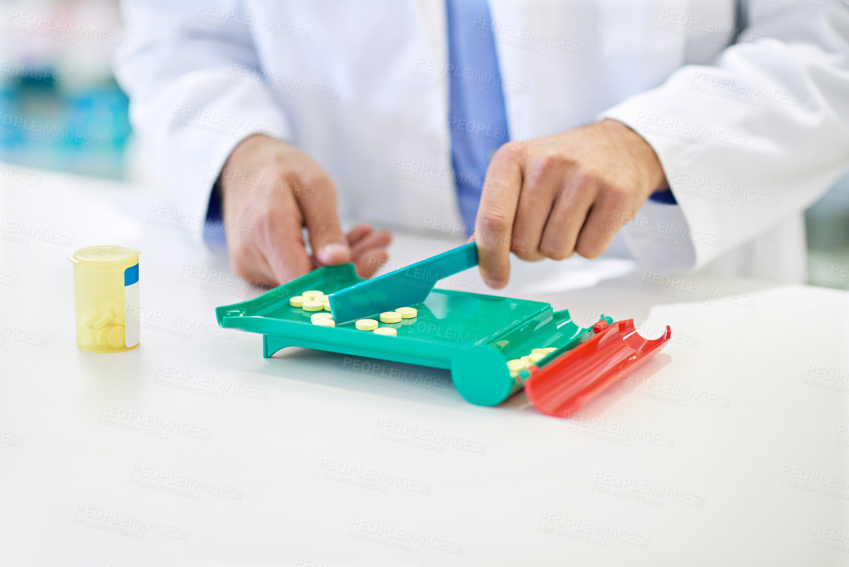 Buy stock photo A pharmacist counting pills