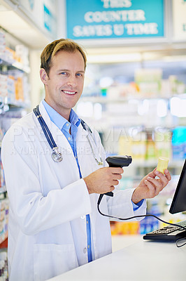 Buy stock photo A pharmacist scanning the price on a bottle of pills