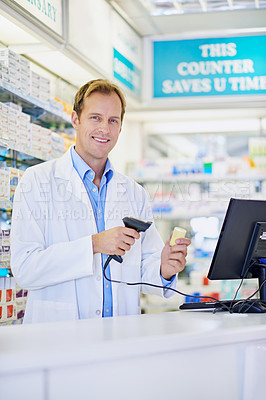 Buy stock photo A pharmacist scanning the price on a bottle of pills