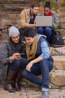 Buy stock photo University, laptop or students with phone on campus steps for learning, research or group project planning. Education, college or gen z friends with teamwork for classroom, assignment and support