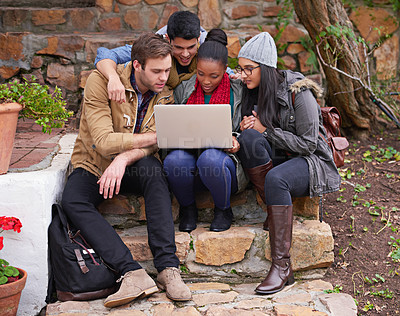 Buy stock photo Cropped shot of a university students using a laptop while sitting on campus
