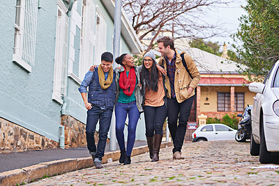 Buy stock photo Shot of a group of college students walking together on campus
