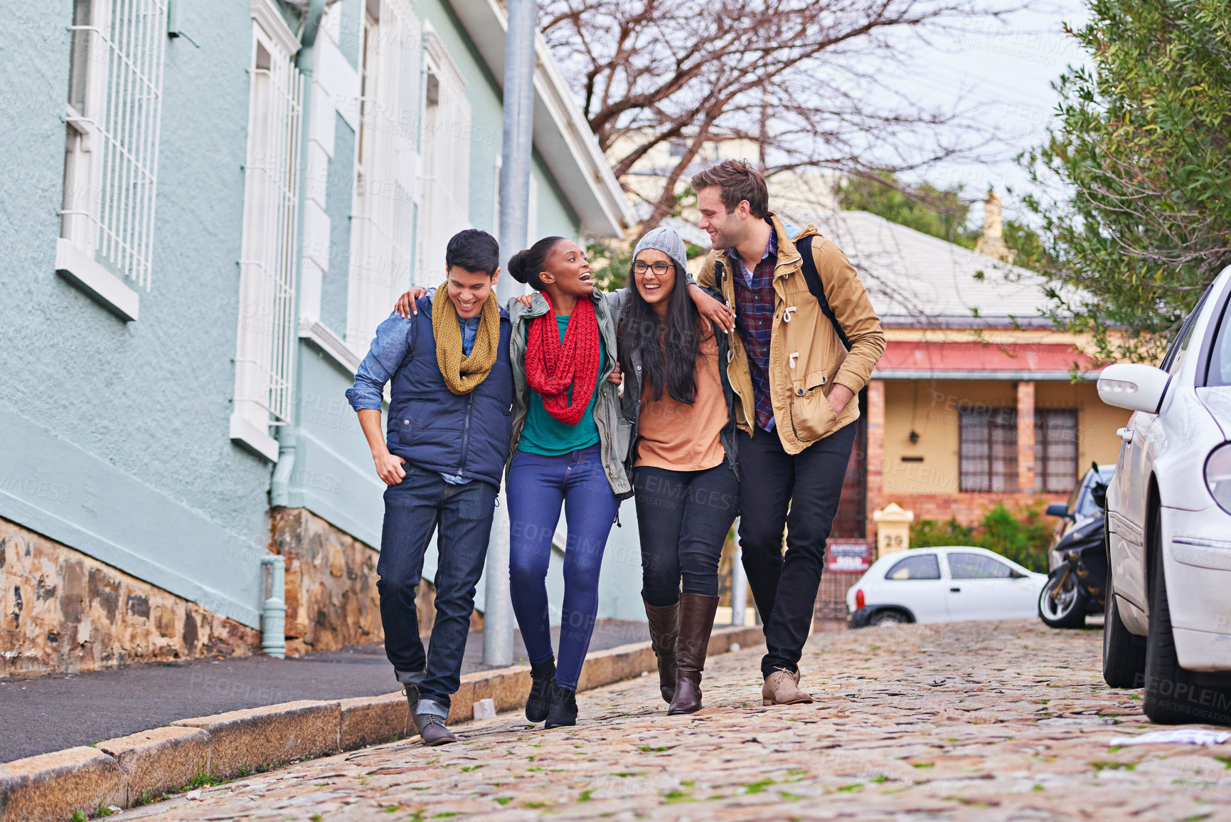Buy stock photo Shot of a group of college students walking together on campus