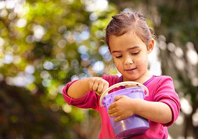 Buy stock photo Girl, kid and face with toy bucket for play, freedom and child development outdoor in nature with bokeh. Person, female and toys for playing, enjoyment or activity in backyard or garden with smile