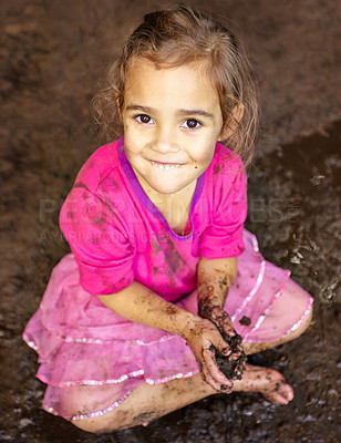 Buy stock photo Girl, kid and portrait with smile in mud for freedom, playing and muddy fun in sunshine weather or outdoor. Child, female and face of person with happiness for activity, enjoyment and relax in dirt