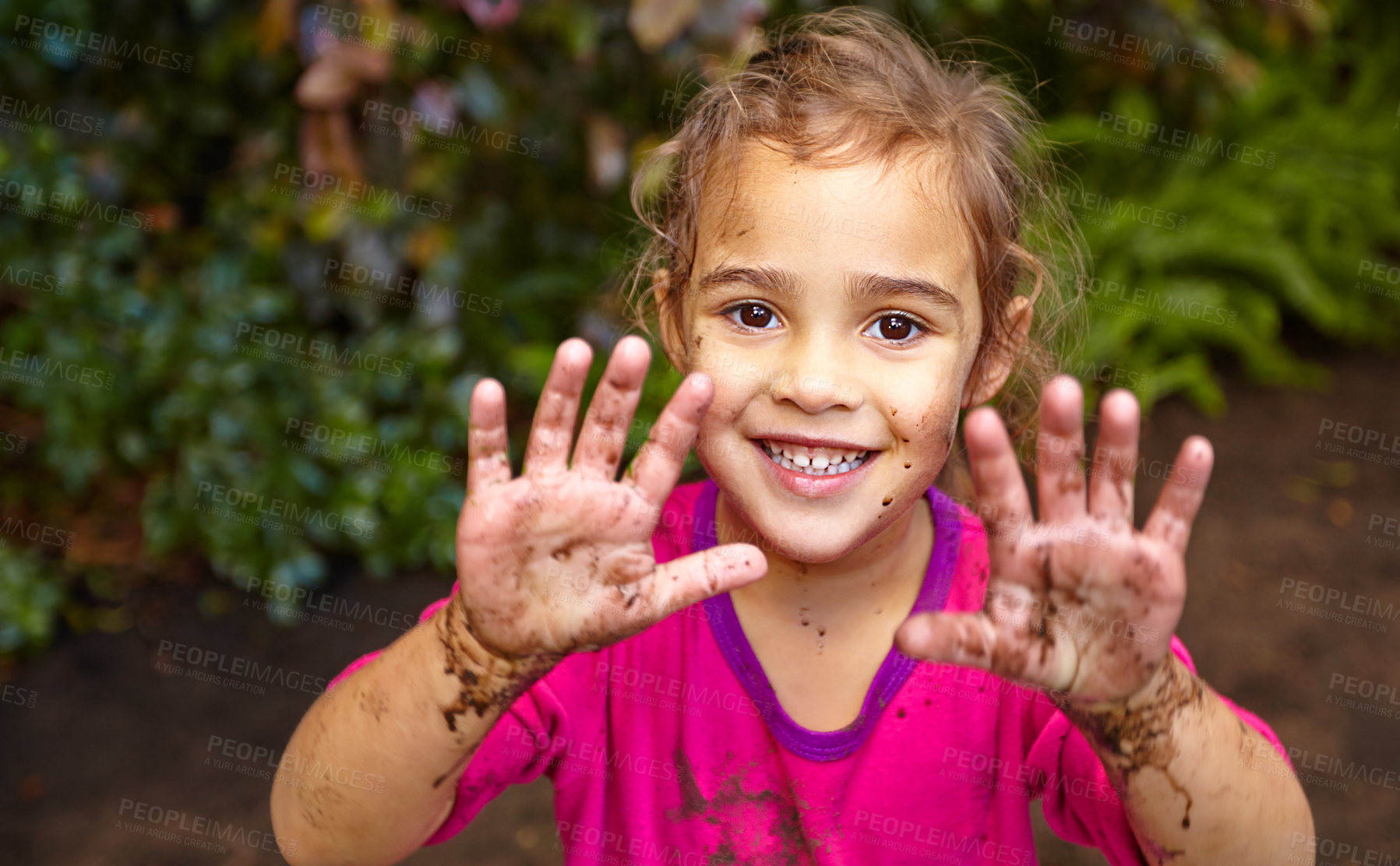 Buy stock photo Shot of a little girl showing her muddy hands while out playing