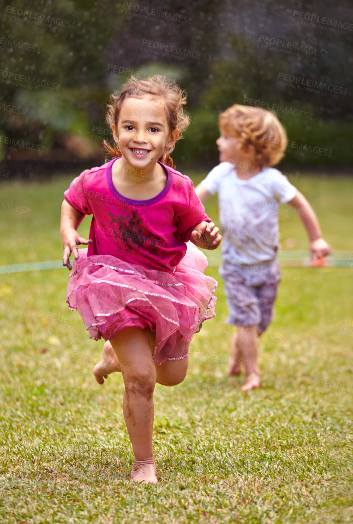 Buy stock photo Shot of a little girl running with her little brother outside