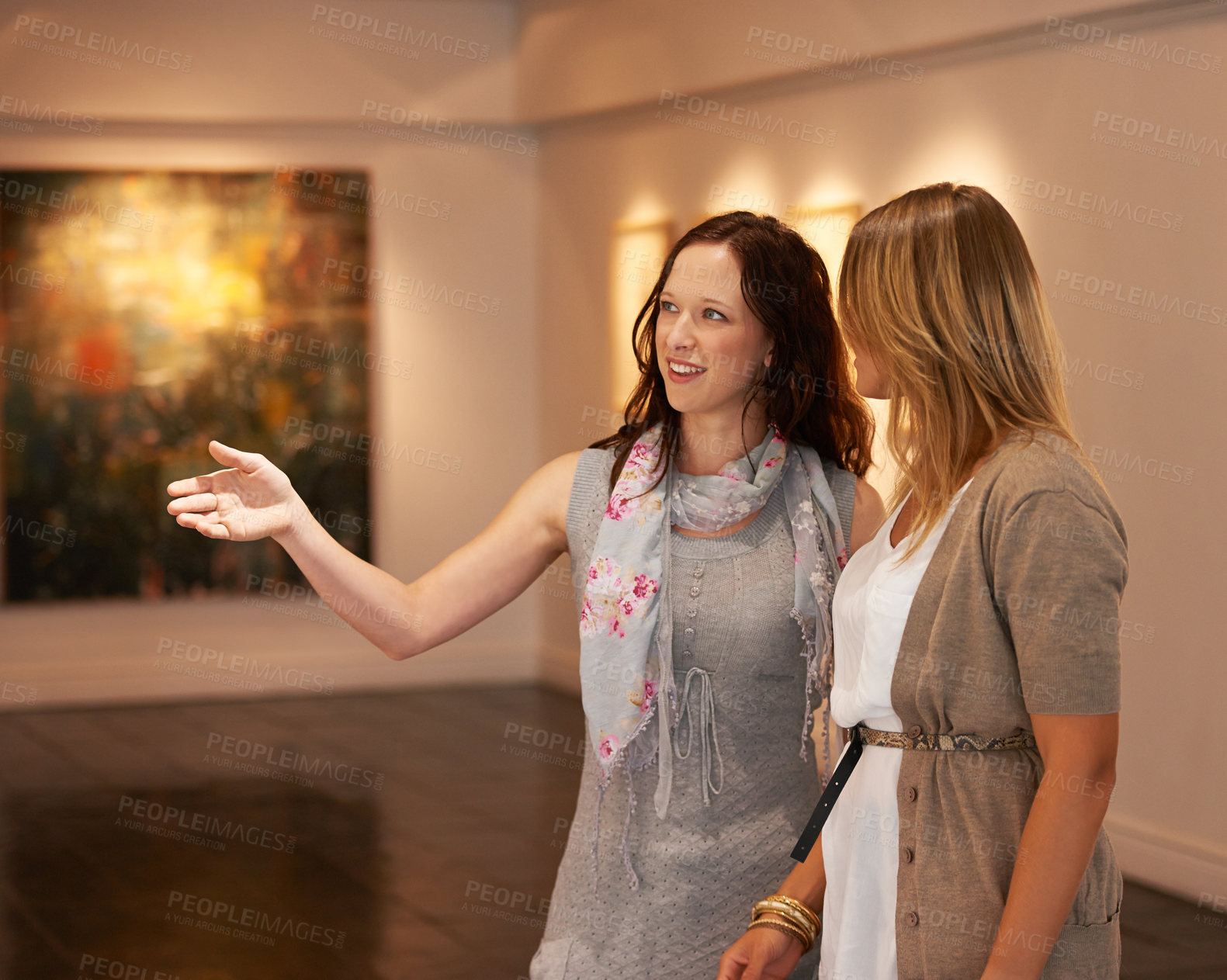 Buy stock photo Museum, exhibition and a woman friends in an art gallery, looking at photography in creative appreciation. Painting, design or culture with an attractive young female and friend at an artwork exhibit