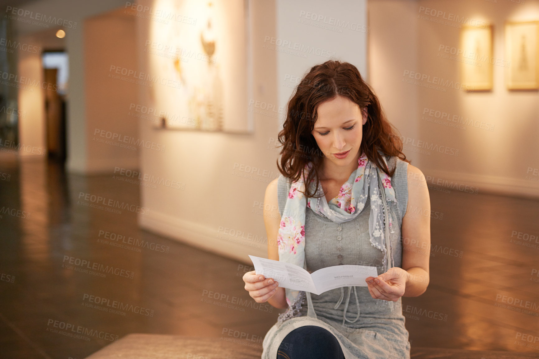 Buy stock photo Museum, exhibition and a woman reading in a painting gallery while learning about creative culture. Brochure, information and a young female person at an art expo or exhibit for artistic photography