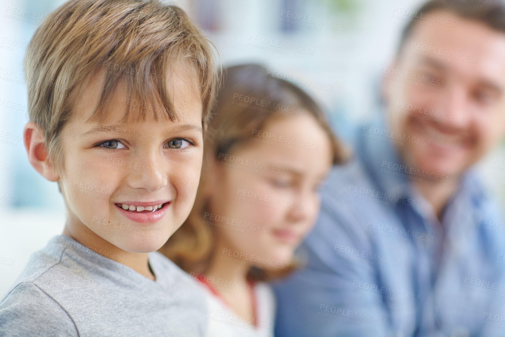 Buy stock photo Portrait of an adorable little boy spending the day with his father and sister at home