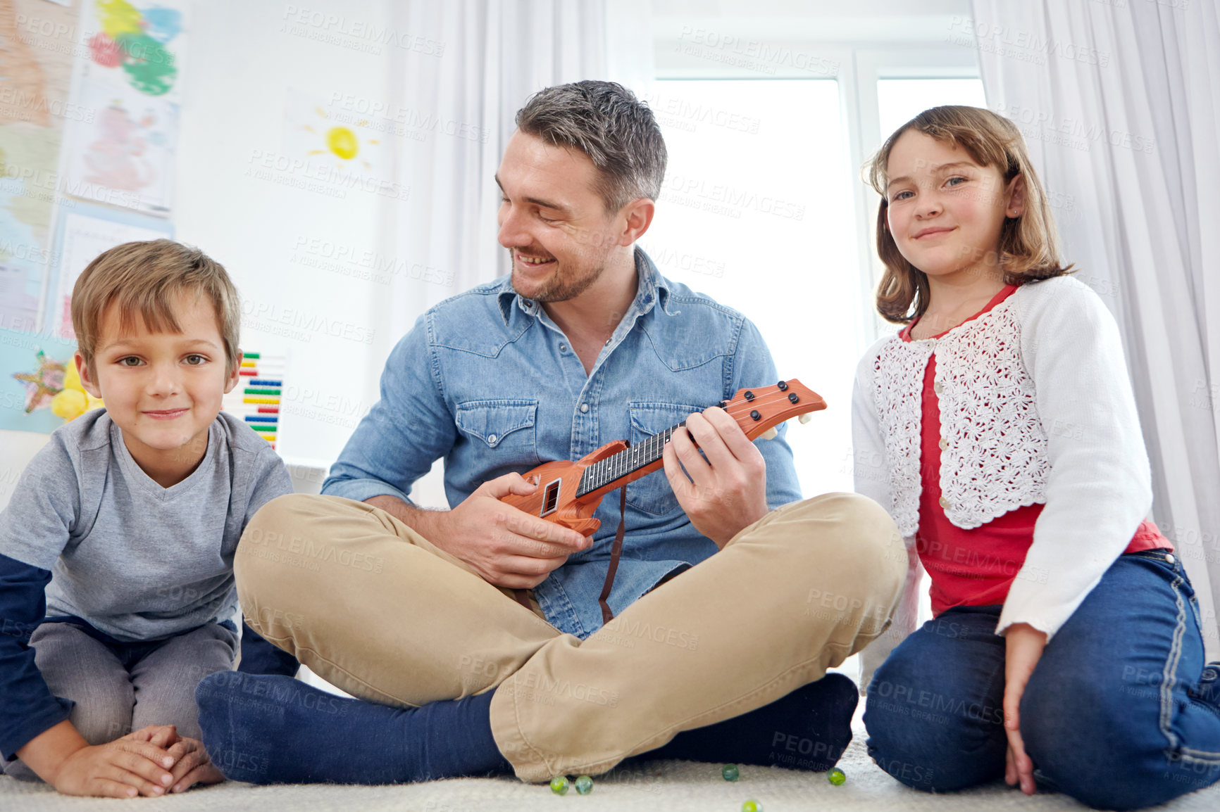 Buy stock photo Education, learning or ukulele with father and kids in bedroom together for bonding or study. Hobby, instrument or music with happy dad, daughter and son on floor of home for child development