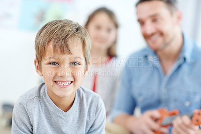 Buy stock photo Portrait of an adorable little boy spending the day with his father and sister at home