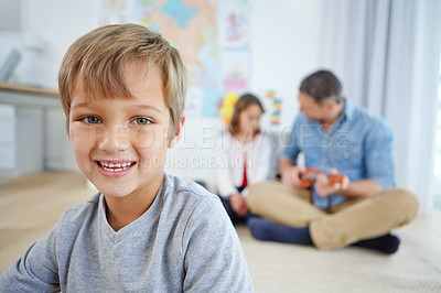 Buy stock photo Portrait of an adorable little boy spending the day with his father and sister at home