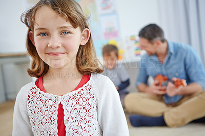 Buy stock photo Portrait of an adorable little girl spending the day with her father and brother at home