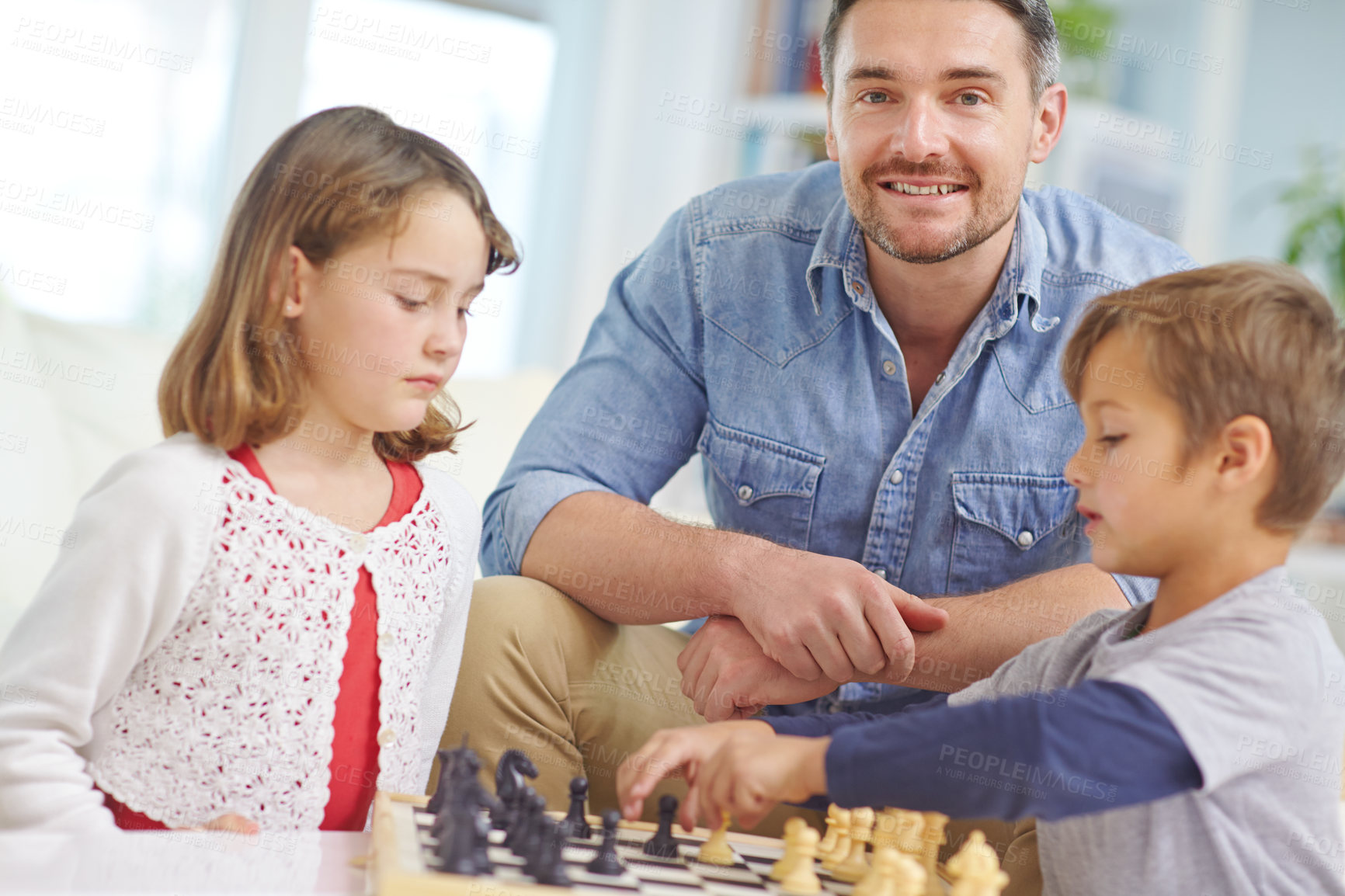 Buy stock photo Father, children and playing chess in home for learning, bonding together and problem solving skills. Family, portrait and people with board game on sofa for challenge, strategic planning or teaching