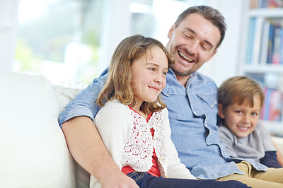 Buy stock photo Shot of of an adorable little girl relaxing on the sofa with her father and brother