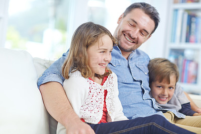 Buy stock photo Shot of of an adorable little girl relaxing on the sofa with her father and brother