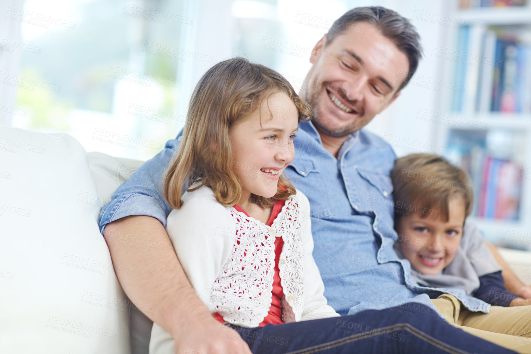 Buy stock photo Shot of of an adorable little girl relaxing on the sofa with her father and brother