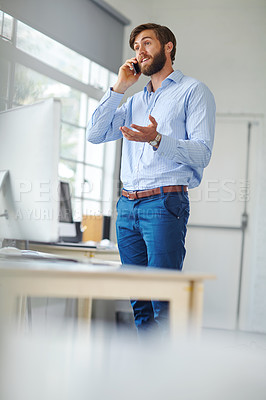 Buy stock photo A handsome male designer talking on his phone