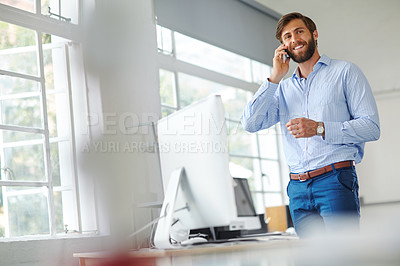 Buy stock photo Shot of a handsome male designer talking on his phone