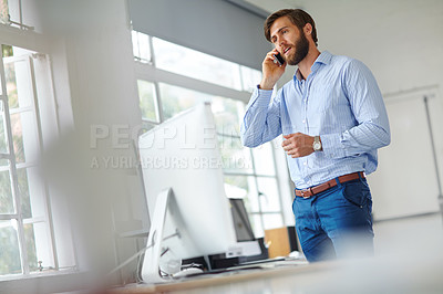 Buy stock photo Shot of a handsome male designer talking on his phone