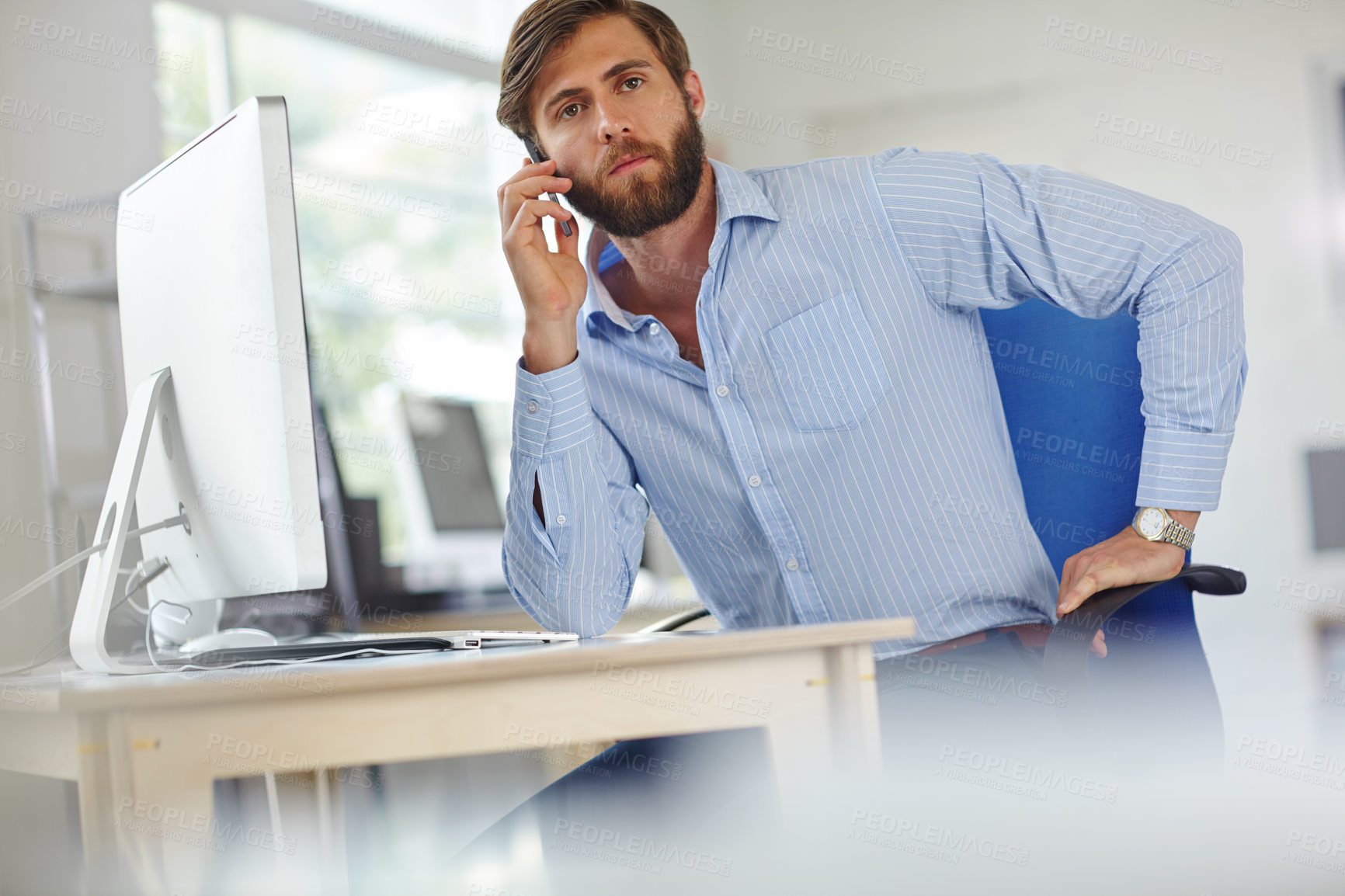 Buy stock photo A handsome male designer talking on his phone