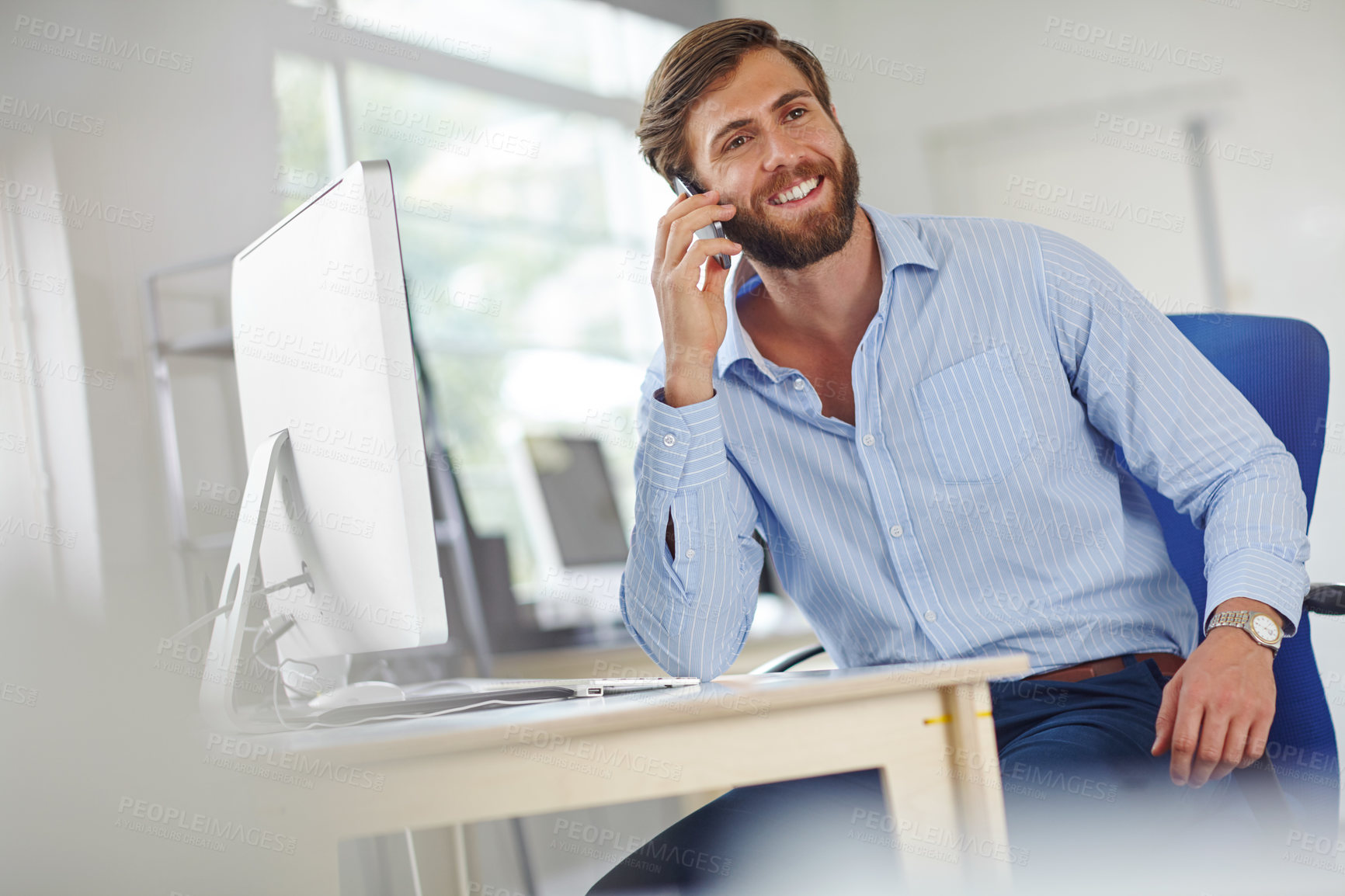 Buy stock photo Shot of a handsome male designer talking on his phone