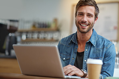 Buy stock photo Portrait of a handsome young man sitting with his laptop in a coffee shop