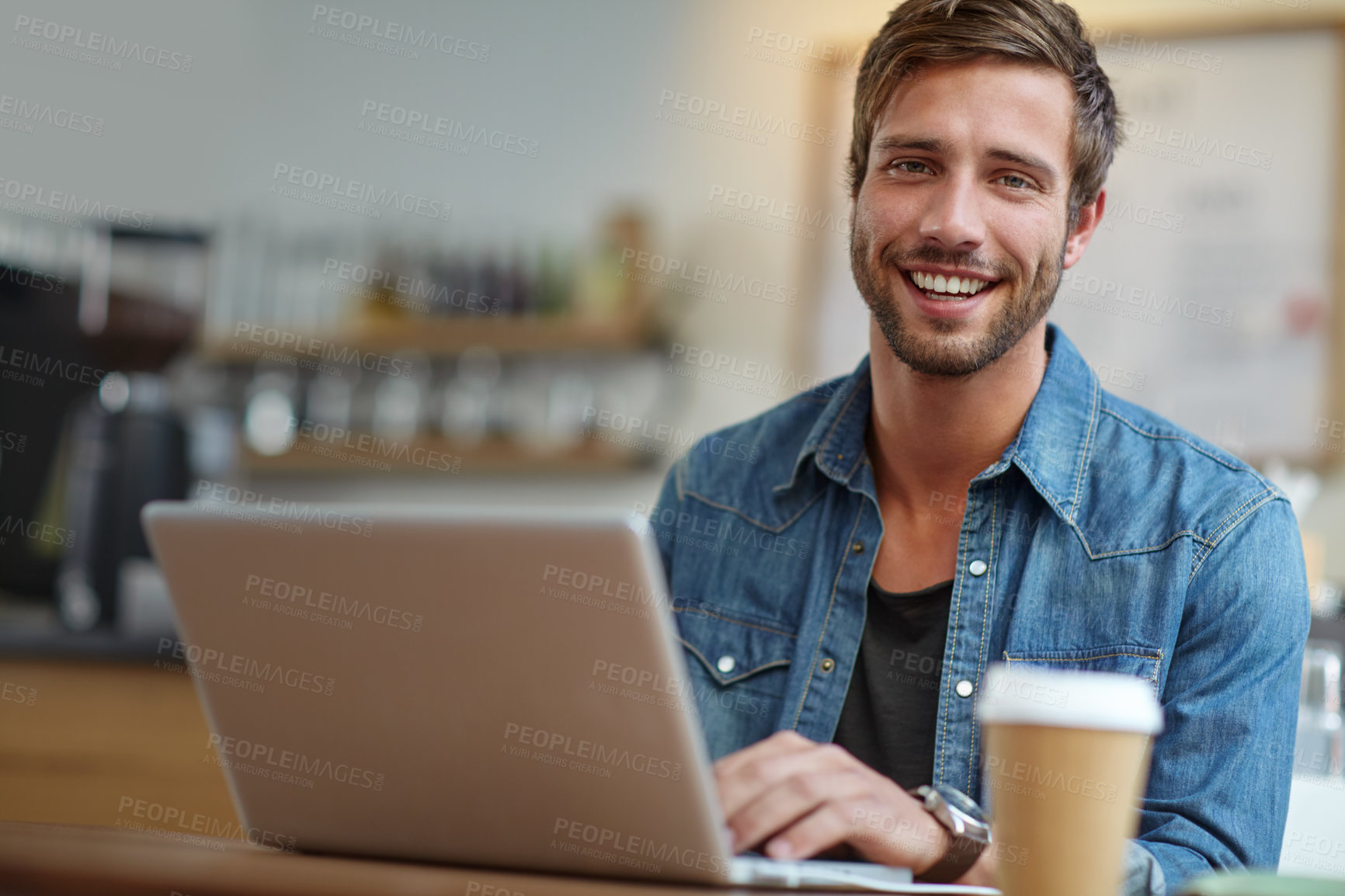 Buy stock photo Portrait of a handsome young man sitting with his laptop in a coffee shop