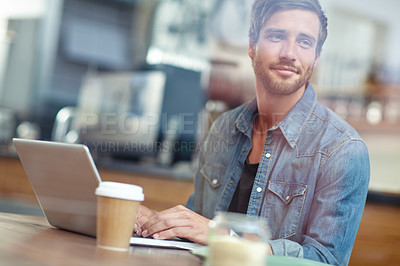 Buy stock photo Shot of a young man looking thoughtful while sitting with his laptop in a coffee shop