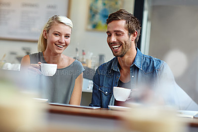 Buy stock photo Shot of a young couple enjoying a date at a coffee shop