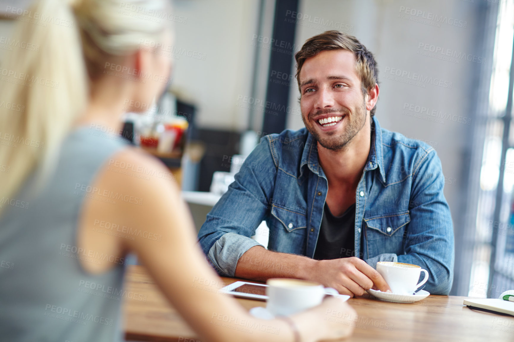 Buy stock photo Shot of a loving young couple on a coffee shop date